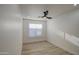 Bright bedroom with wood-look flooring and large window with blinds at 3335 E San Angelo Ave, Gilbert, AZ 85234