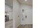 Bright entryway with wood-look flooring and a view into the adjacent kitchen at 3335 E San Angelo Ave, Gilbert, AZ 85234