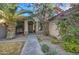 Welcoming front entrance with a paved walkway, vibrant bougainvillea, and a charming facade at 3335 E San Angelo Ave, Gilbert, AZ 85234