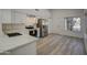 Contemporary kitchen boasting white cabinetry, stainless steel appliances, and a marble countertop at 3335 E San Angelo Ave, Gilbert, AZ 85234