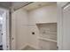 Laundry room with white shelving, washer/dryer hookups, and wood-look flooring at 3335 E San Angelo Ave, Gilbert, AZ 85234