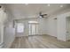 Inviting living room with wood-look floors, a ceiling fan, and French doors leading to the backyard at 3335 E San Angelo Ave, Gilbert, AZ 85234