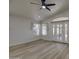 Bright living room with wood-look flooring and French doors leading to the backyard at 3335 E San Angelo Ave, Gilbert, AZ 85234