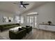 Living room with stylish furniture, vaulted ceilings, and access to the backyard at 3335 E San Angelo Ave, Gilbert, AZ 85234