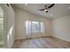Large main bedroom with wood-look floors, ceiling fan, and backyard views at 3335 E San Angelo Ave, Gilbert, AZ 85234