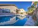 A beautiful pool with the home's reflection shimmering in the water at 3335 E San Angelo Ave, Gilbert, AZ 85234