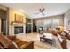 Inviting living room with fireplace, plantation shutters, and ceiling fan at 3651 E Crest Ln, Phoenix, AZ 85050