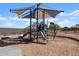 A playground with slides and climbing structures, shaded by a canopy at 36971 W Prado St, Maricopa, AZ 85138