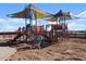 A colorful playground with slides, climbing structures, and shade canopies at 36971 W Prado St, Maricopa, AZ 85138