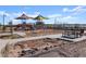 Community playground with slides, swings, and a shaded picnic area at 37028 W Prado St, Maricopa, AZ 85138