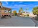 Spacious backyard featuring a pool, covered patio, and lush landscaping at 4208 E Tether Trl, Phoenix, AZ 85050