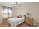 Bedroom with ceiling fan, carpet, window with curtains, and wicker dresser at 4208 E Tether Trl, Phoenix, AZ 85050