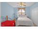 Guest bedroom featuring ceiling fan, wood-frame bed, sliding closet doors, and carpet at 4208 E Tether Trl, Phoenix, AZ 85050