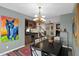 Dining room with chandelier, colorful artwork, and a built-in dry bar at 4208 E Tether Trl, Phoenix, AZ 85050
