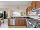 Kitchen with dark granite countertops, wood cabinetry, and stainless steel appliances at 4208 E Tether Trl, Phoenix, AZ 85050