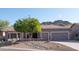 Single-story home with a two-car garage, mature landscaping, and mountain views at 4889 S Nighthawk Dr, Gold Canyon, AZ 85118
