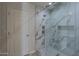 Modern bathroom with a large walk-in shower and marble tile at 501 E Desert Hills Estate Dr, Phoenix, AZ 85086