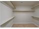 Spacious walk-in closet with ample shelving and hanging rods at 501 E Desert Hills Estate Dr, Phoenix, AZ 85086