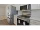Stainless steel appliances in a modern kitchen with white cabinets at 501 E Desert Hills Estate Dr, Phoenix, AZ 85086