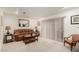 Living room with a brown couch, coffee table, and sliding glass door at 7436 E Chaparral Rd # B162, Scottsdale, AZ 85250