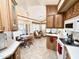 Eat-in kitchen with dining area, white appliances, and ample wood cabinetry at 822 S Beryl Dr, Apache Junction, AZ 85119