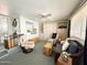 Living space with built-in shelves, two armchairs, ceiling fan, and sliding glass door to the outside at 822 S Beryl Dr, Apache Junction, AZ 85119