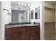 Bathroom with granite countertop, vanity, and walk-in closet at 8500 E Indian School Rd # 129, Scottsdale, AZ 85251