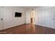 Bedroom with hardwood flooring, closet, and ensuite bathroom access at 8500 E Indian School Rd # 129, Scottsdale, AZ 85251