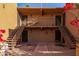 Two-story condo building exterior with balconies, stairs, and vibrant bougainvillea at 8500 E Indian School Rd # 129, Scottsdale, AZ 85251