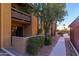 Exterior view of the building with lush landscaping and a walkway at 8500 E Indian School Rd # 129, Scottsdale, AZ 85251