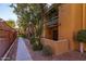 Exterior view of the building with palm trees and fenced walkway at 8500 E Indian School Rd # 129, Scottsdale, AZ 85251