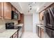 Modern kitchen with granite counters, stainless steel appliances, and wood cabinetry at 8500 E Indian School Rd # 129, Scottsdale, AZ 85251