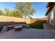 Spacious backyard with a fire pit, artificial turf, and privacy walls at 8820 W Bloomfield Rd, Peoria, AZ 85381