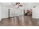 Inviting living room with wood-look flooring, ceiling fan, and access to the kitchen at 8820 W Bloomfield Rd, Peoria, AZ 85381