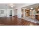 Open-concept living and dining area with wood-look flooring and view of the kitchen at 925 S Longwood S Loop, Mesa, AZ 85208