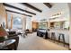 Open living room with exposed beams, a fireplace, and a view of the kitchen at 101 E Echo Ln, Phoenix, AZ 85020