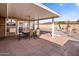 Covered patio with outdoor dining set, overlooking a landscaped backyard at 10522 W Bayside Rd, Sun City, AZ 85351