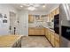 Kitchen with tile floor, wood cabinets, and view to backyard at 10522 W Bayside Rd, Sun City, AZ 85351