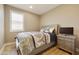 Comfortable bedroom with a bed, nightstand, and a TV at 10731 E Texas Ave, Mesa, AZ 85212