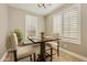 Cozy breakfast nook with a charming table, chairs, and large window with shutters at 10731 E Texas Ave, Mesa, AZ 85212
