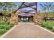 Stone pillars and a pergola create an inviting clubhouse entrance at 10731 E Texas Ave, Mesa, AZ 85212