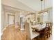 Dining area with a rustic wood table, white upholstered chairs, and an open concept layout at 10731 E Texas Ave, Mesa, AZ 85212