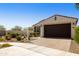 Charming home with a paver driveway, desert landscaping, and a two-car garage at 10731 E Texas Ave, Mesa, AZ 85212