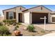 Charming single-story home with a brown garage door and desert landscaping at 10731 E Texas Ave, Mesa, AZ 85212