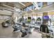 Fitness center with cardio equipment, TVs, and windows overlooking the pool at 10731 E Texas Ave, Mesa, AZ 85212