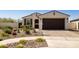 Inviting single-story home with a desert landscape and a two-car garage at 10731 E Texas Ave, Mesa, AZ 85212