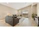 Living area with comfortable sectional sofa, area rug, and access to backyard at 10731 E Texas Ave, Mesa, AZ 85212