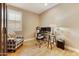 Functional home office with a glass desk, comfortable seating, and ample workspace at 10731 E Texas Ave, Mesa, AZ 85212