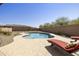 Relaxing pool area with lounge chairs, surrounded by desert landscaping and a privacy wall at 10731 E Texas Ave, Mesa, AZ 85212