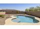 Backyard oasis featuring a sparkling pool with a tanning ledge and desert landscaping at 10731 E Texas Ave, Mesa, AZ 85212